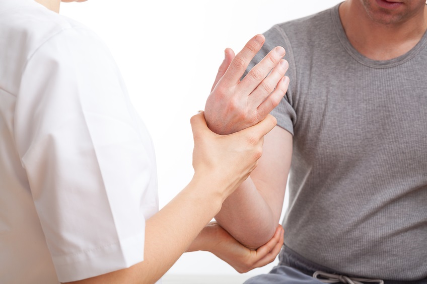 Physiotherapist with patient Tennis elbow physiotherapy